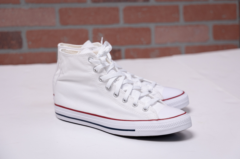 Converse All Star white on brick background